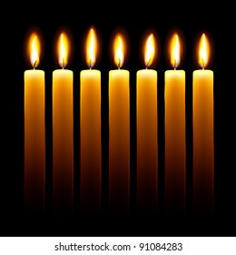 Burning candles on black background.