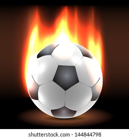 Burning in flames lying soccer ball in the dark