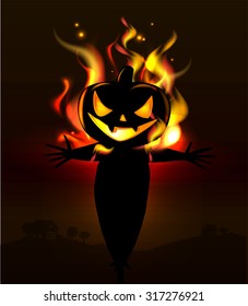 Burning Halloween scarecrow in the dark. 
