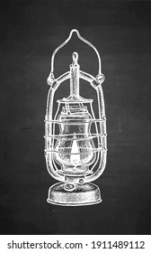 Burning kerosene lamp. Antique oil lantern. Chalk sketch on blackboard background. Hand drawn vector illustration. Retro style.