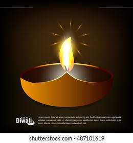 burning oil lamp diya on Happy Diwali Holiday, ancient Hindu festival of lights, on blurred background.