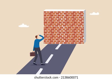 Business barrier, obstacle or difficulty, road block or career struggle, trouble or problem to be solved, prohibited or dead end concept, confused businessman walk on the road to brick wall barrier.