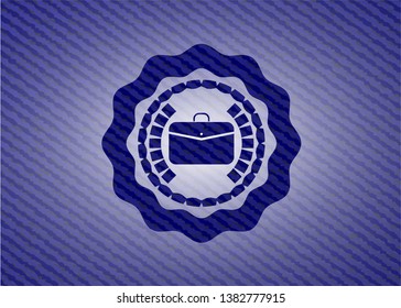 business briefcase icon inside badge with denim texture