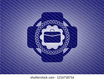 business briefcase icon inside emblem with denim high quality background