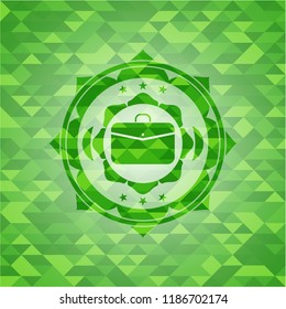 business briefcase icon inside green emblem with mosaic background