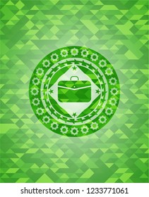 business briefcase icon inside green emblem with mosaic ecological style background