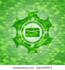 business briefcase icon inside green mosaic emblem. 