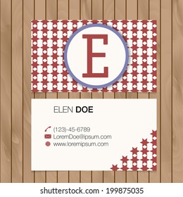 Business card with alphabet letter on a wood background. Vector template editable