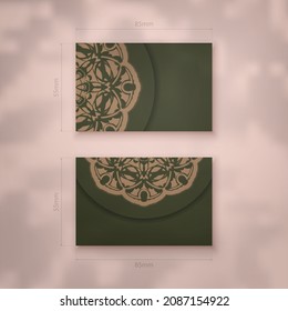 Business card in green with luxurious brown ornaments for your business.