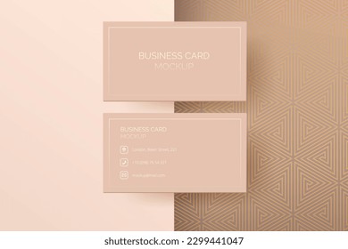 Business card mockup with a luxury beige and gold geometric mosaic pattern background. Use it to create a stylish and modern corporate identity or stationery. Modern, trendy and luxurious mock up.