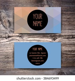 Business card template with creative colorful geometric pattern on wooden background