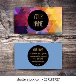 Business card template with creative geometric pattern on wooden background