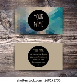 Business card template with creative geometric pattern on wooden background