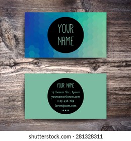 Business card template with creative geometric pattern on wooden background
