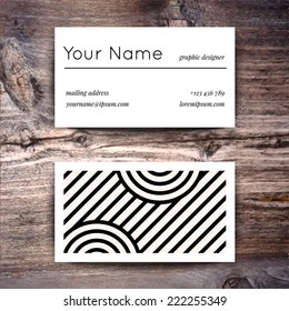 Business card template with creative white and black retro pattern on wooden background