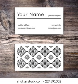Business card template with creative white and black retro pattern on wooden background