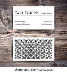 Business card template with creative white and black retro pattern on wooden background