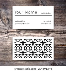 Business card template with creative white and black retro pattern on wooden background