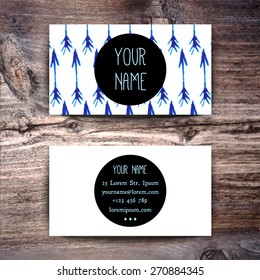 Business card template with watercolor pattern on wooden background