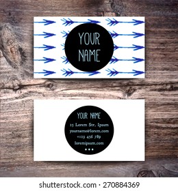 Business card template with watercolor pattern on wooden background
