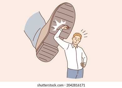 Business challenge and confidence concept. Young smiling businessman cartoon character standing deflecting blow from boots sole vector illustration 