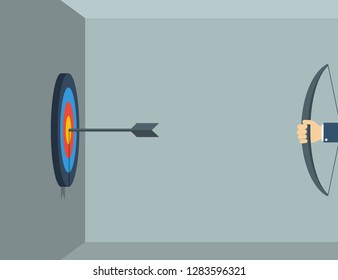 Business concept. Businessman hand holding a bow and shoots a target hanging on the wall. Eps10