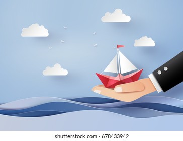 
business concept of freedom and believe ,origami made paper sailing boat on hand. The illustrations do the same paper art and digital crafts style