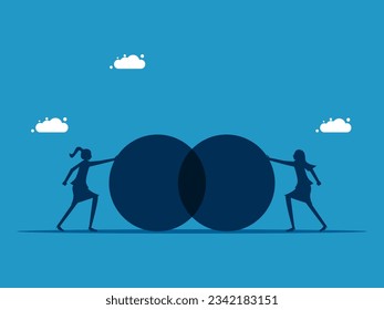 Business cooperation. Two businesswomen pushing the circle towards each other