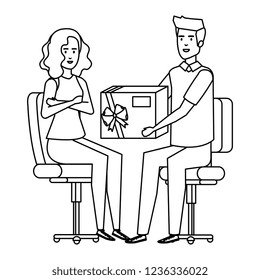 business couple sitting in chairs giving gift