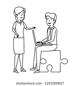 business couple sitting in puzzle piece with laptop