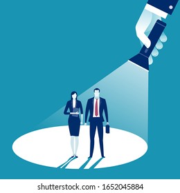 Business Couple In The Spotlight. A Hand Holding A Flashlight Pointing At Standing Couple. Business Vector Illustration