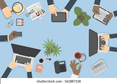 Business desk top view with hands, laptop, documents and tablet. Concept of team work, brainstorming and conference.