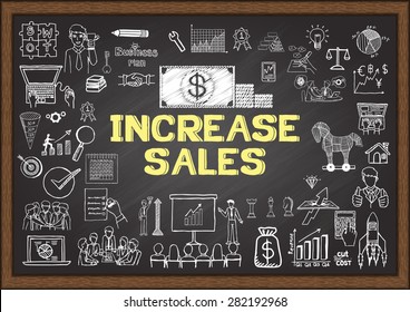 Business doodles about increase sales on chalkboard.
