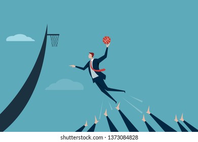 Business executive jumps high with the help of team members to score points. Concept for team achieving goals.
