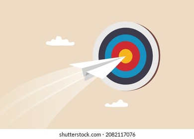 Business goal or target, challenge or improvement to achieve success, win business competition or motivation concept, paper plane origami flying through dartboard or archer bullseye target.