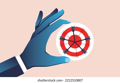 Business goals, reaching goals, advertising marketing and audience goals, job search and career recruitment, hand holding a target that is accurately hit by an arrow in the bullseye