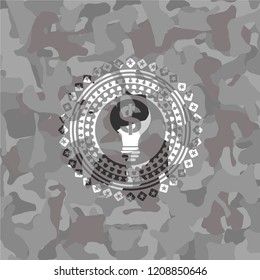 business idea icon inside grey camouflaged emblem
