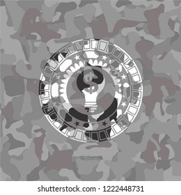 business idea icon inside grey camouflaged emblem