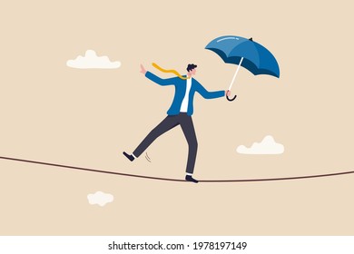 Business or investment risk protection, challenge, danger and difficulty to overcome to success in work and career concept, confident brave businessman ropewalker equilibrium walk on high tight rope.