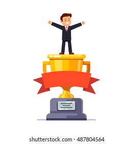 Business leader standing on big winner golden cup pedestal spreading his hands in triumph gesture celebrating achievement. Modern flat style vector illustration isolated on white background.