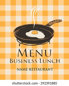 business lunch with a frying pan and fried eggs on the background of a checkered tablecloth