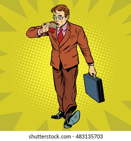 Business man drinking coffee on the go, pop art retro vector illustration