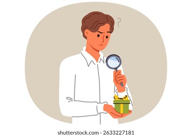 Business man examines suspiciously small gift box, using magnifying glass to spot catch. Official guy received gift as bribe for lobbying interests of company or unfair competition