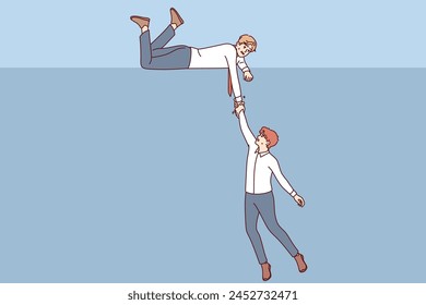 Business man extends helping hand to colleague who is falling into abyss, showing support in difficult situation. Support from corporate partner for human in trouble and at risk of bankruptcy