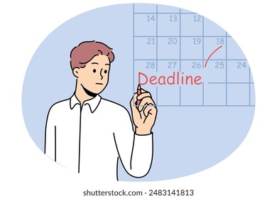 Business man fills in calendar and makes note of deadlines so as not to miss day of reporting to customer. Guy works as team leader and keeps track of deadlines for data to complete tasks.