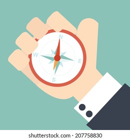 Business man holding compass