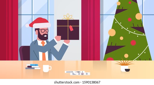 business man holding gift present box businessman sitting at workplace merry christmas happy new year winter holidays celebration concept modern office interior flat portrait horizontal vector