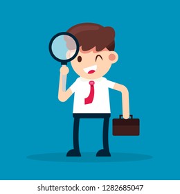 Business man looking through Magnifying Glass