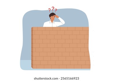 Business man looks behind stone barrier in search of new opportunities for career growth. Curious guy stands near barrier and wonders how to overcome problems that have arisen on path to success.