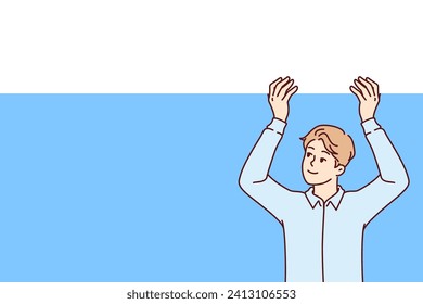 Business man raises blank banner above head and looks up with smile, recommending that pay attention to offer. Promoter guy with copy space for advertising your company or marketing proposal
